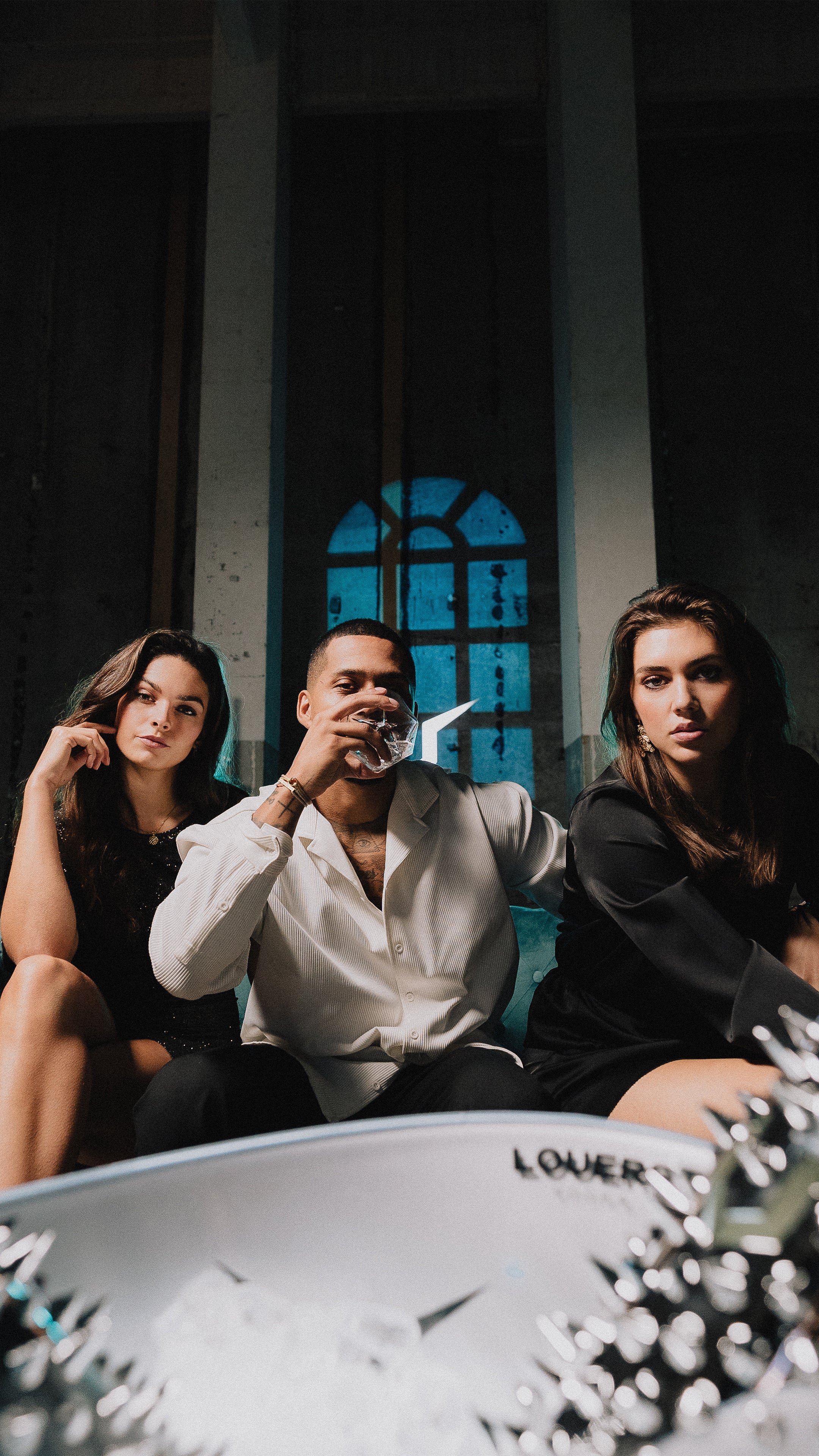 models posing with LOUERS vodka bottles